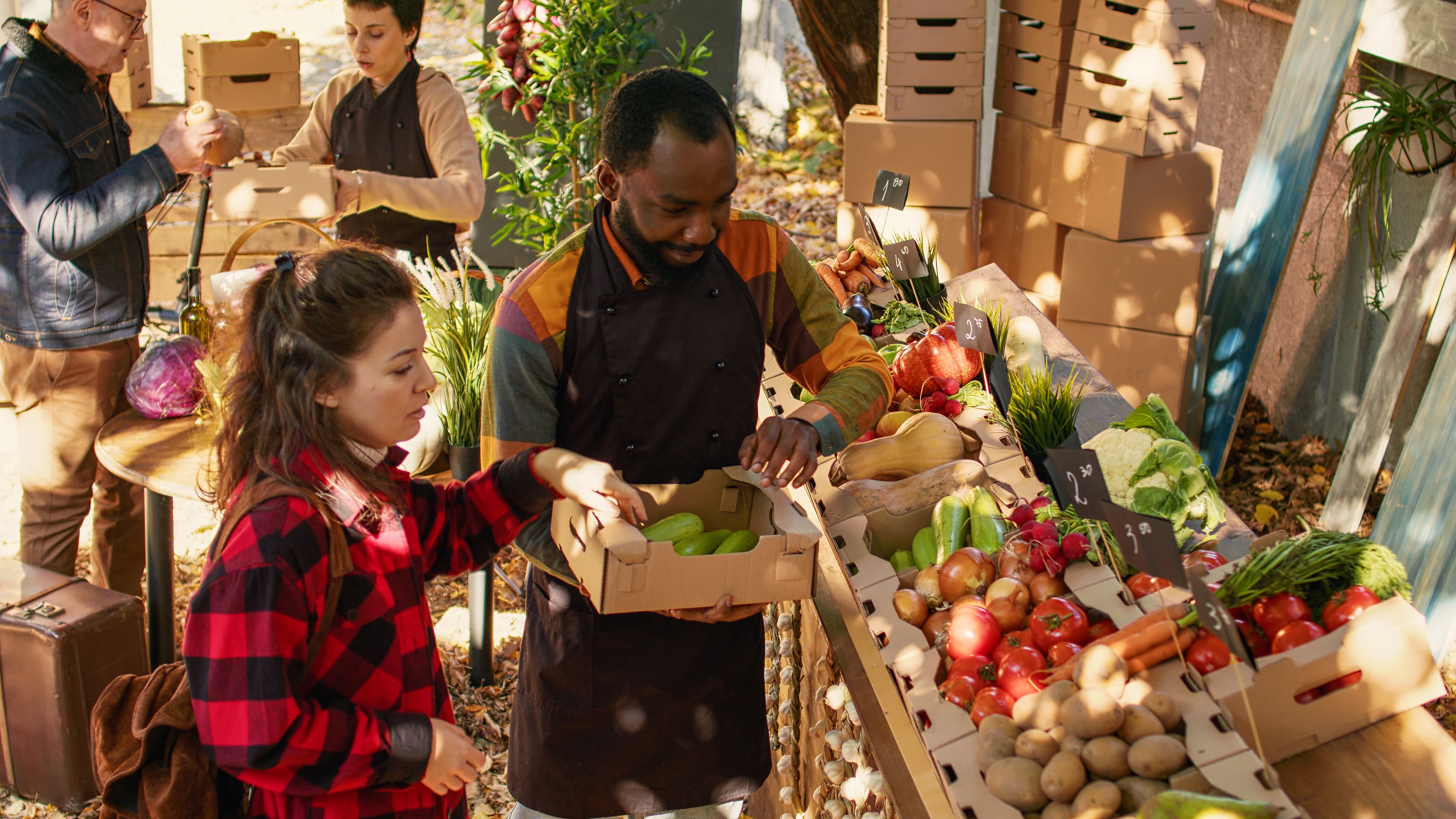 Diverse local vendors preparing healthy market counter